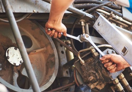 combine-machine-service-mechanic-repairing-motor-outdoors (1)_11zon