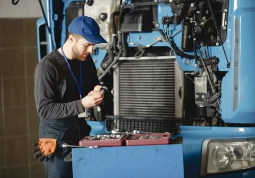 men-repair-truck-man-teaches-repair-car-two-men-uniform_11zon